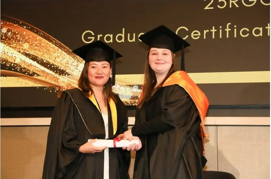 IHM graduate receiving a certificate