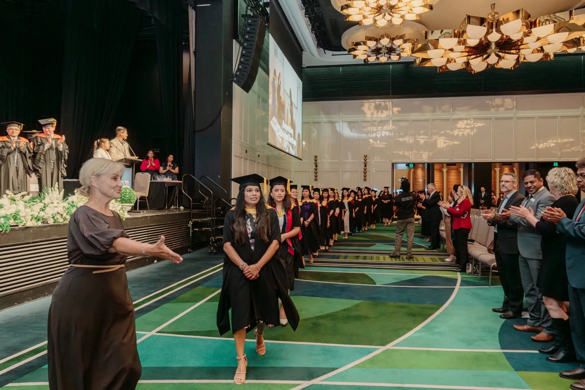 IHM graduation portrait on stage