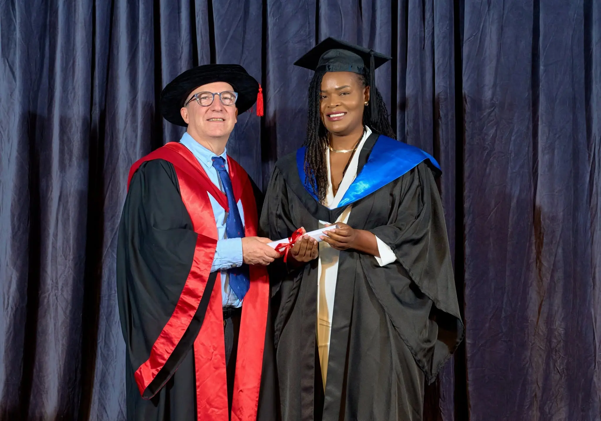 IHM graduation portrait with faculty member