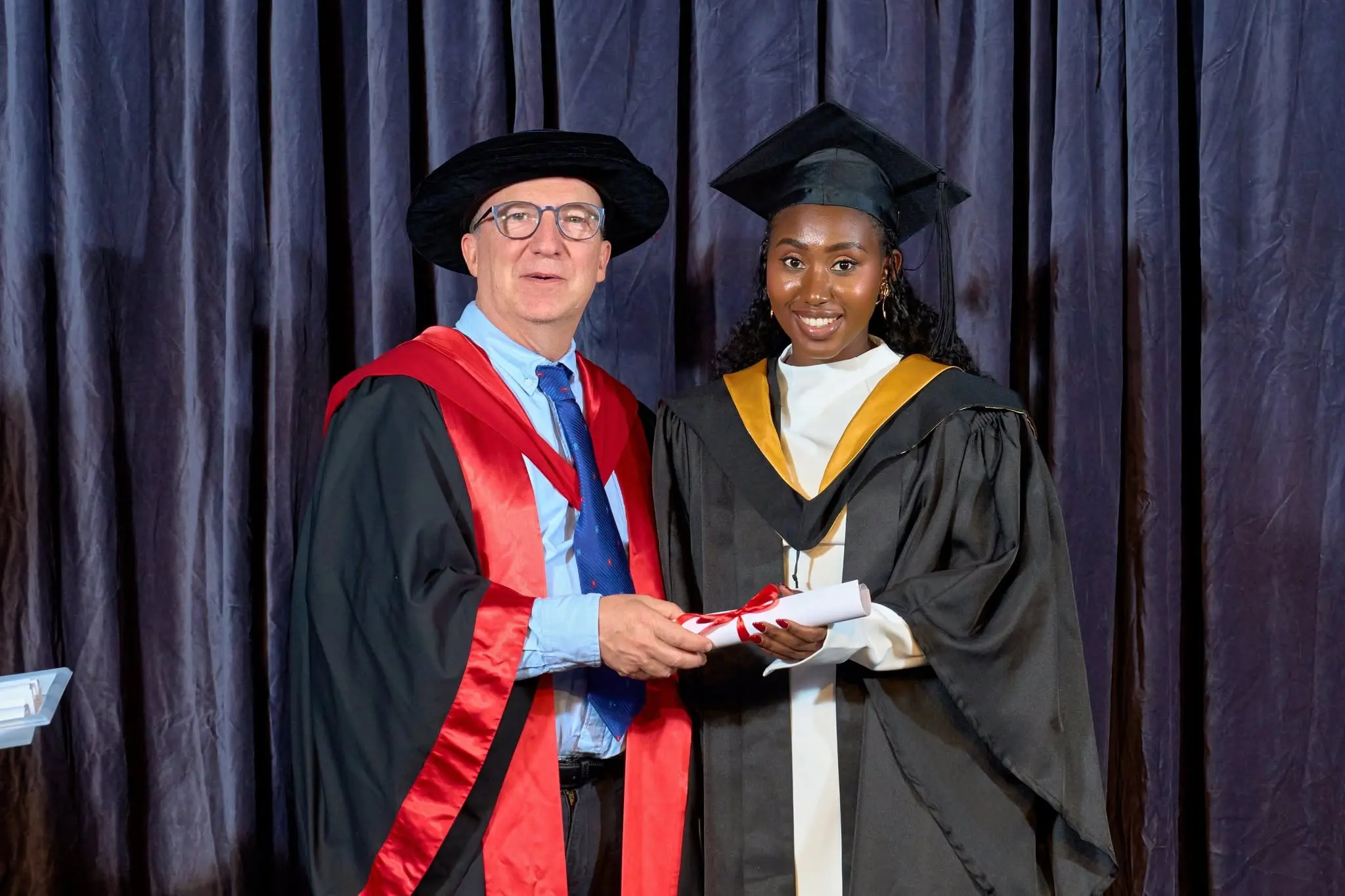 IHM graduate portrait with certificate