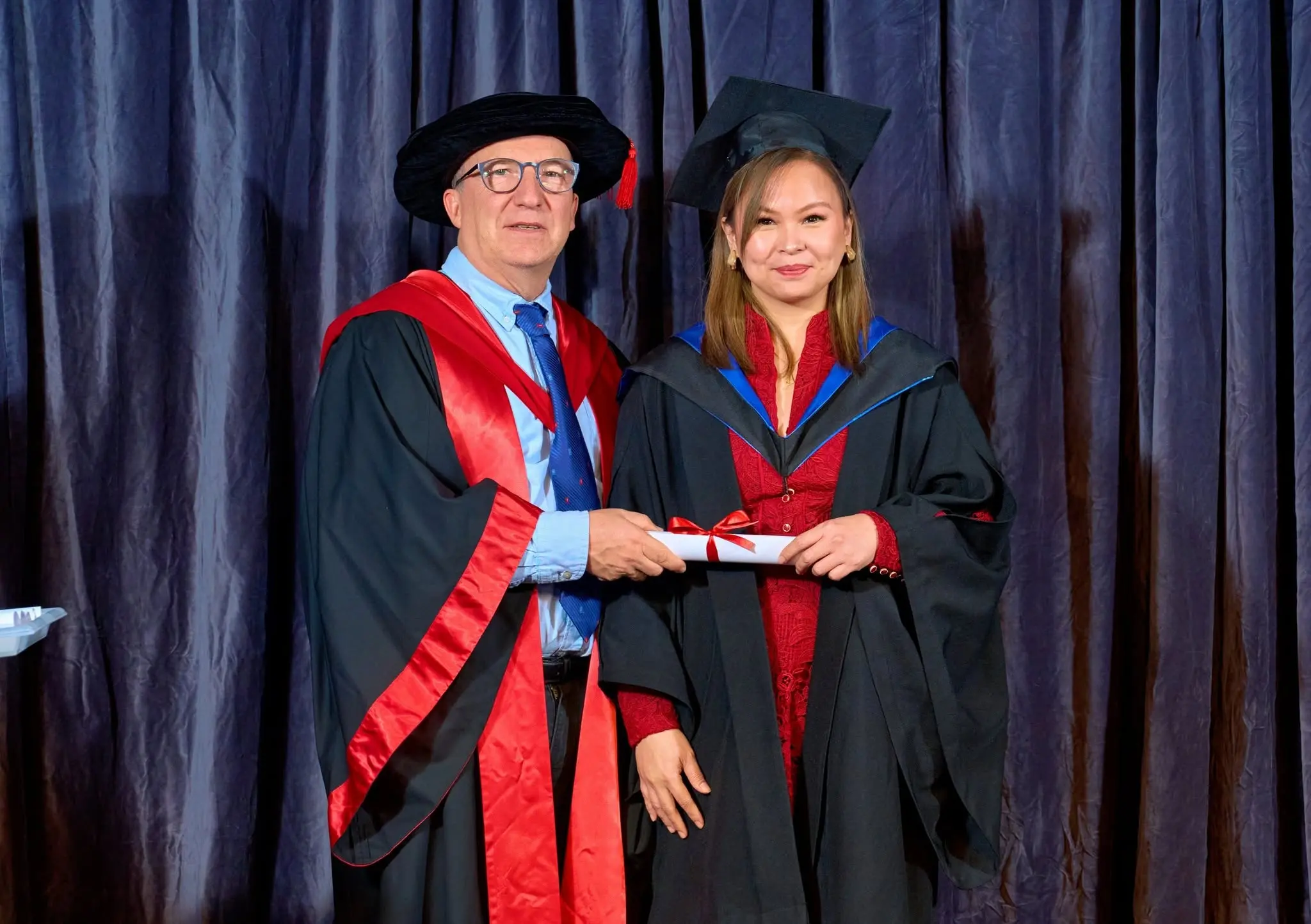 IHM graduate on stage with certificate