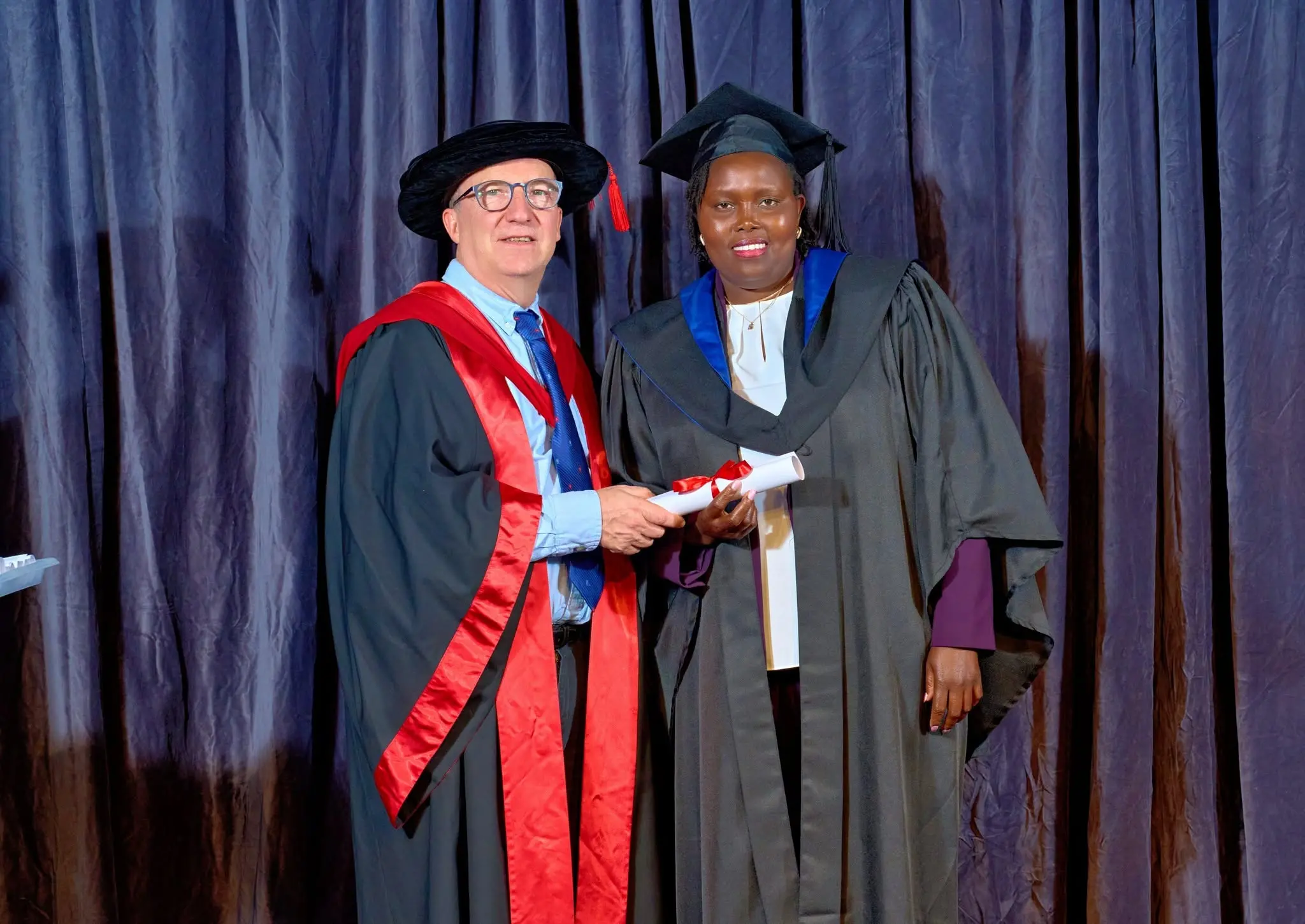IHM graduate receiving diploma on stage