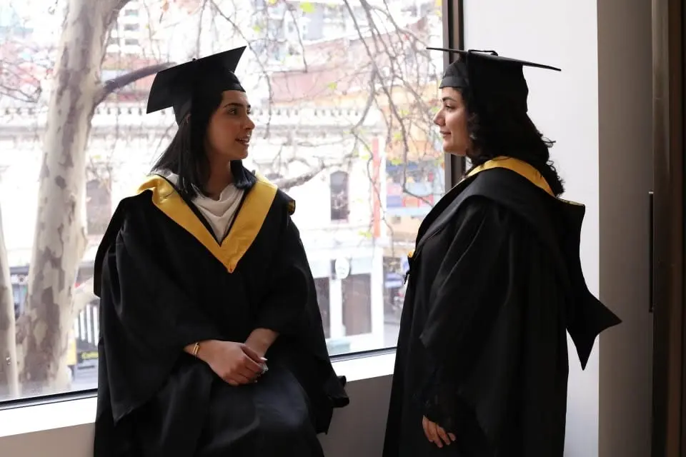 IHM alumni celebrating a graduation portrait moment