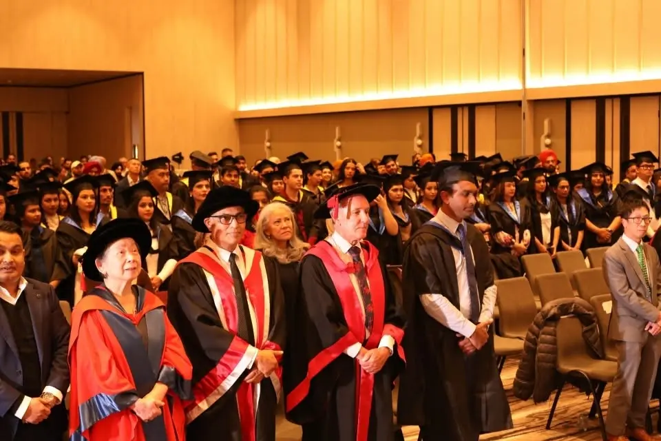 IHM alumni portrait with certificate